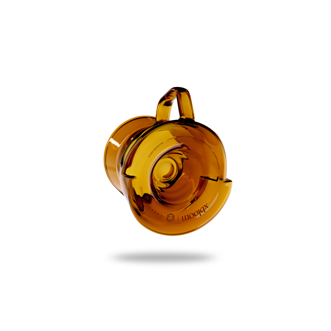 Amber-colored glass object with a handle on a white background