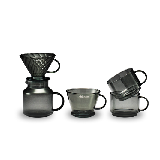 Set of black glass coffee brewing equipment with 'xbloom' branding on a white background