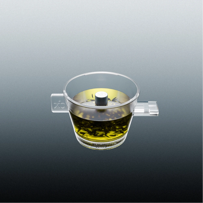 Clear omni tea dripper with a tea infuser on a gray background