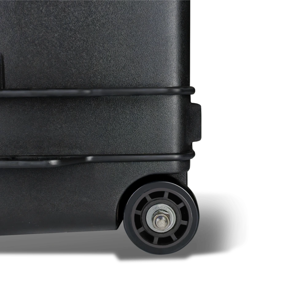 Close-up of a black suitcase wheel on a light gray background