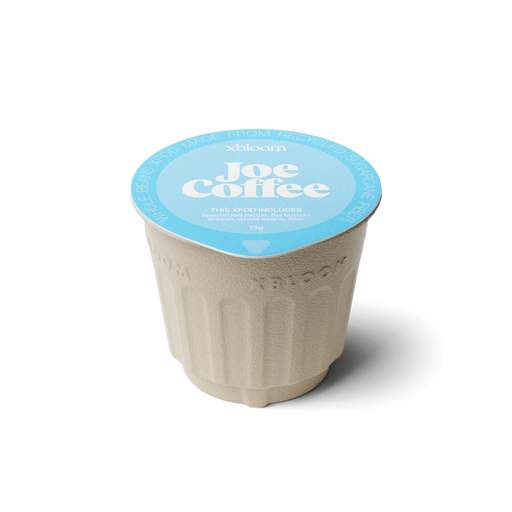 xBloom x Joe Coffee coffee xpod with a blue llid on a white background